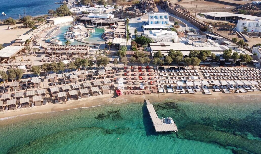 Aerial,Drone,Bird's,Eye,View,From,Famous,Beach,Of,Paraga Aerial drone bird's eye view from famous beach of Paraga featuring famous night club of Skorpios and Santanna with largest pool in Europe, Mykonos island, Cyclades, Greece